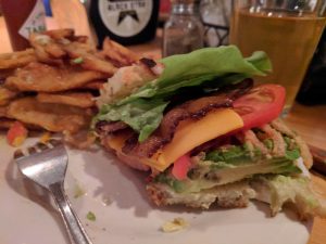 Avocado club sandwich on sourdough bread. Bacon added, of course.